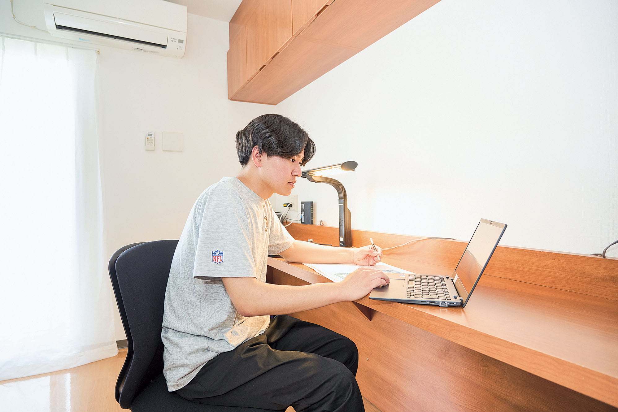 Student studying in a dormitory room